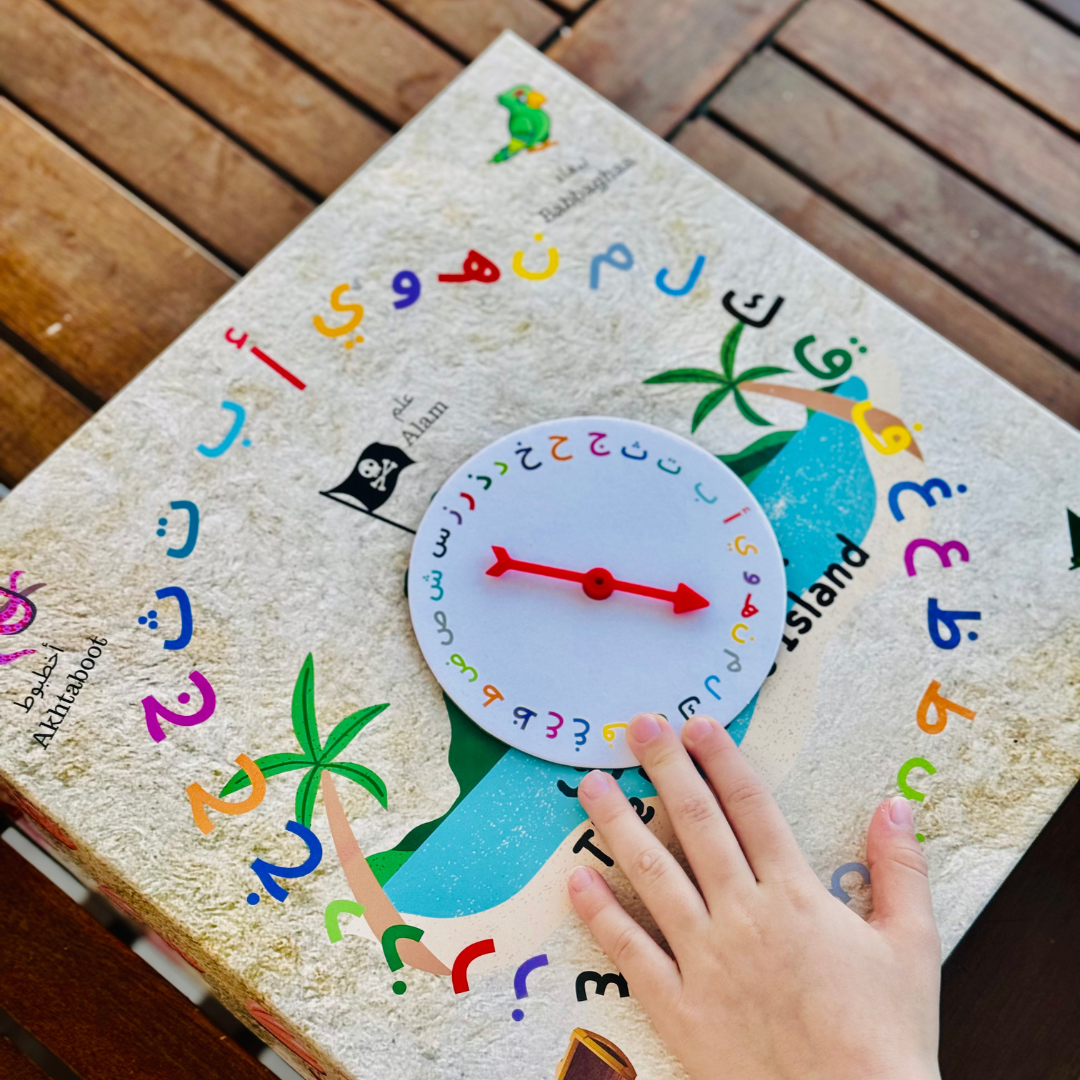 Child spinning a colorful wheel to learn Arabic letters and vocabulary.